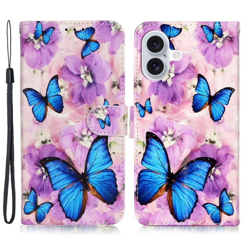 Folio-hoesje iPhone 16 Telefoonhoesje Blauwe Vlinders En Paarse Bloemen Met Riempje