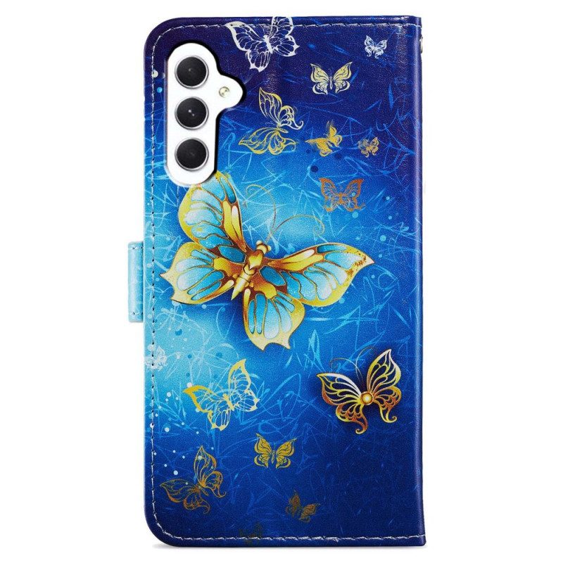 Folio-hoesje Samsung Galaxy A55 5g Telefoonhoesje Gouden Vlinder Op Blauwe Achtergrond Met Riempje